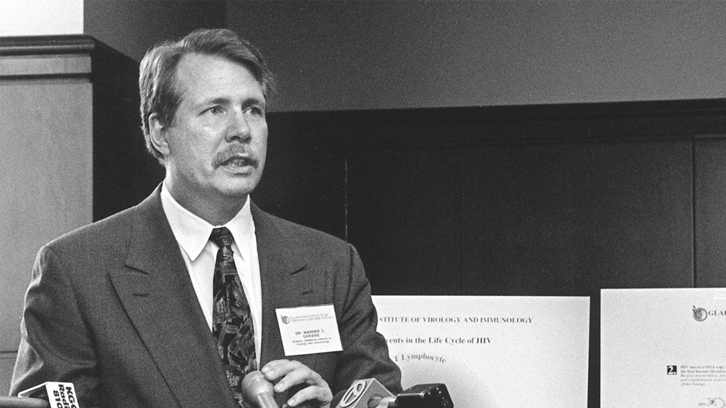 Black and white photo of Warner Greene speaking at a podium