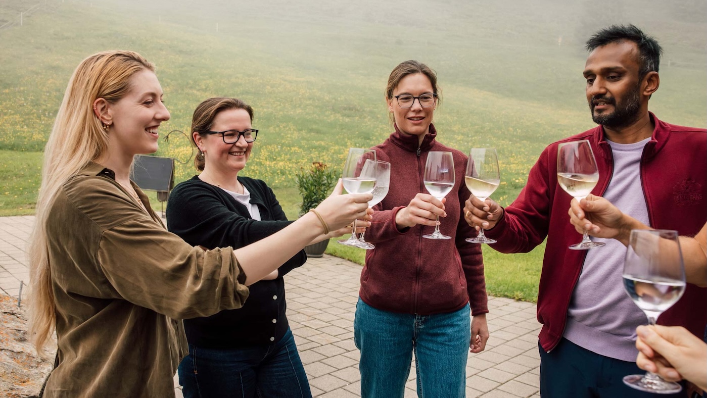NOMIS fellow toast with wine glasses