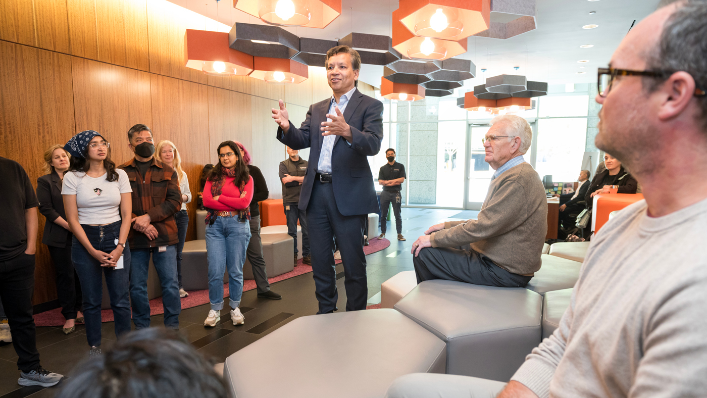 Gladstone president Deepak Srivastava speaking to a group in the Gladstone lobby.