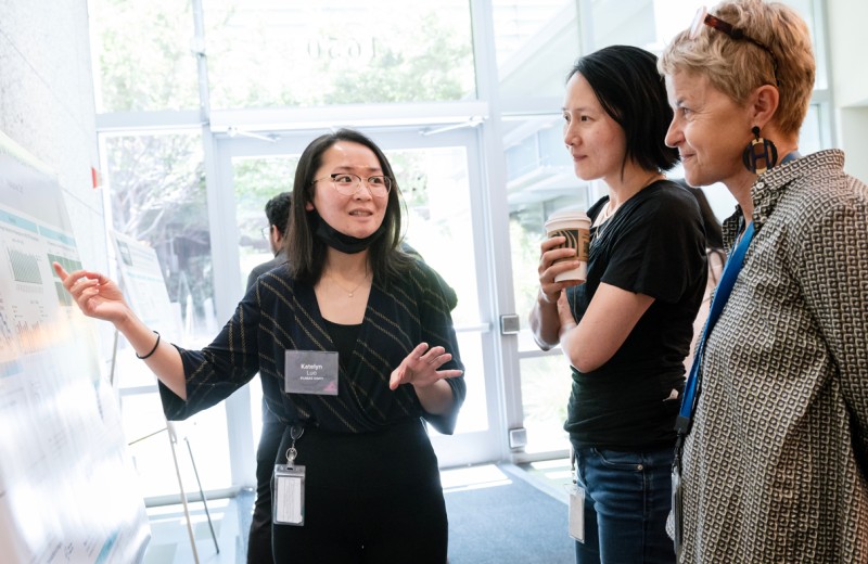 A PUMAS intern explains her research project at the poster session.