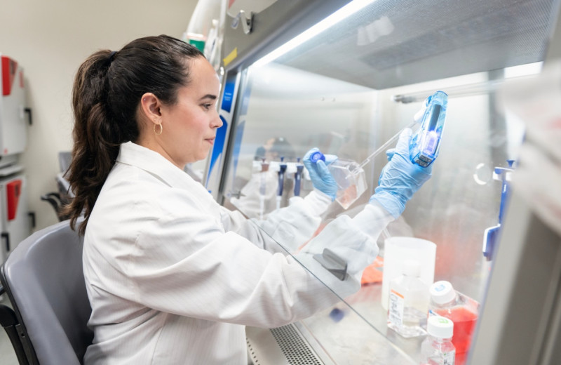 a woman scientist conducting an experiment at a lab bench