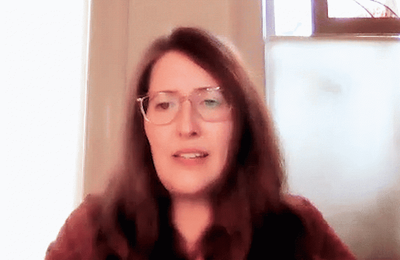 Gif of Courtney Dickerson pushing up her glassese