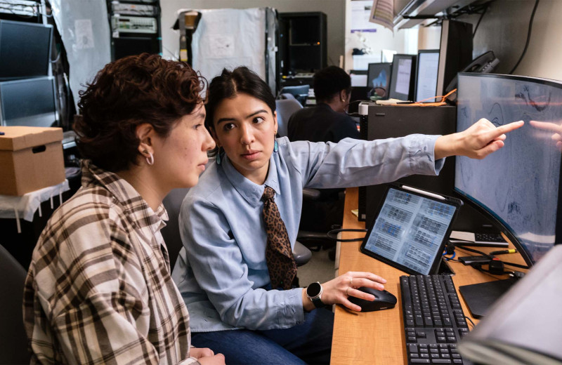 Audrey Magsig working with another scientist at a computer.