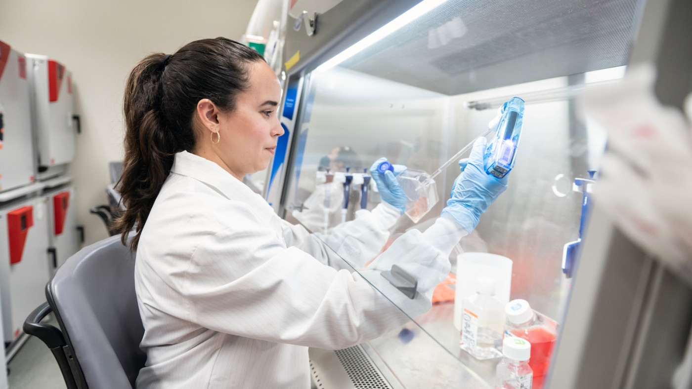 a woman scientist conducting an experiment at a lab bench