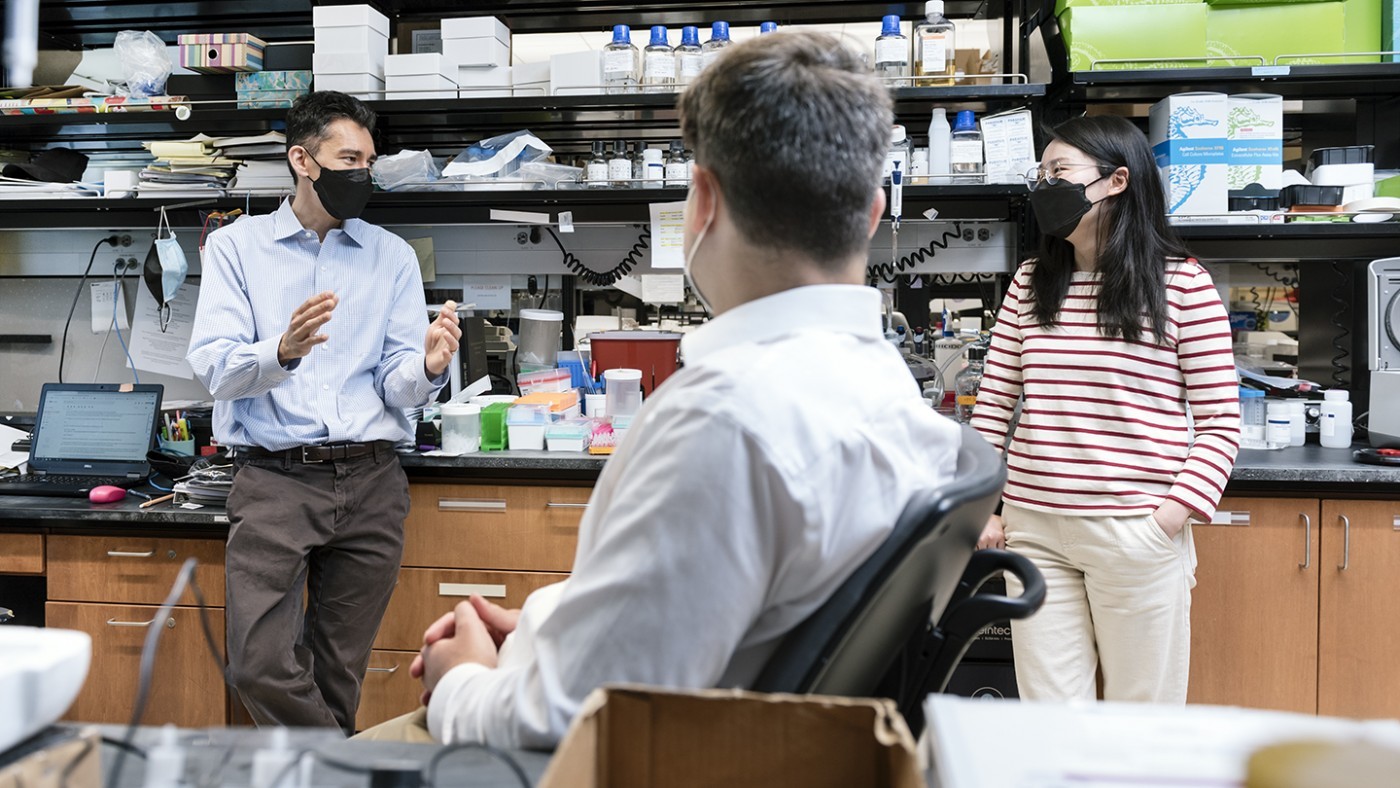 Scientists talking in the lab—Ken Nakamura, Zak Doric, and Huihui Li