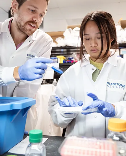 Scientist working with an intern at a lab bench
