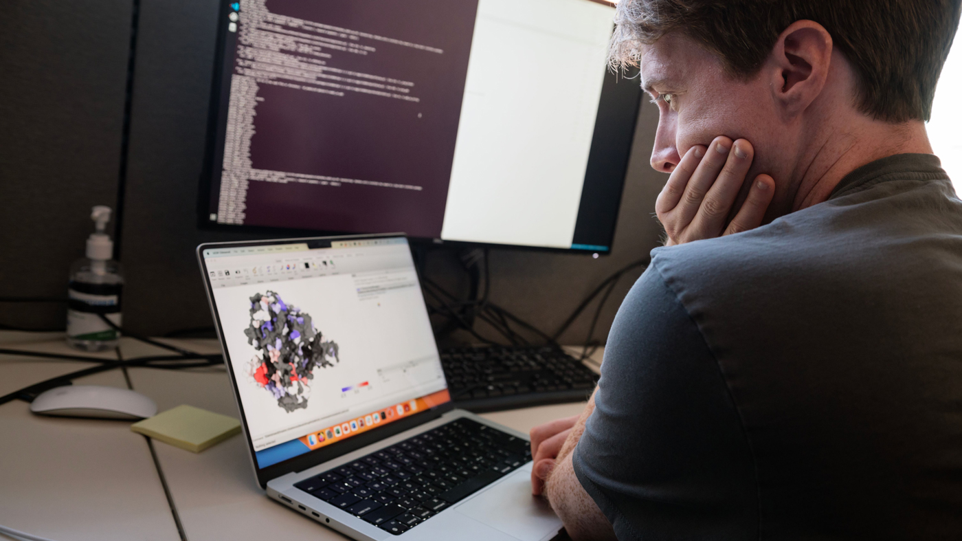 Carl Ward on a laptop in the Marson Lab. 