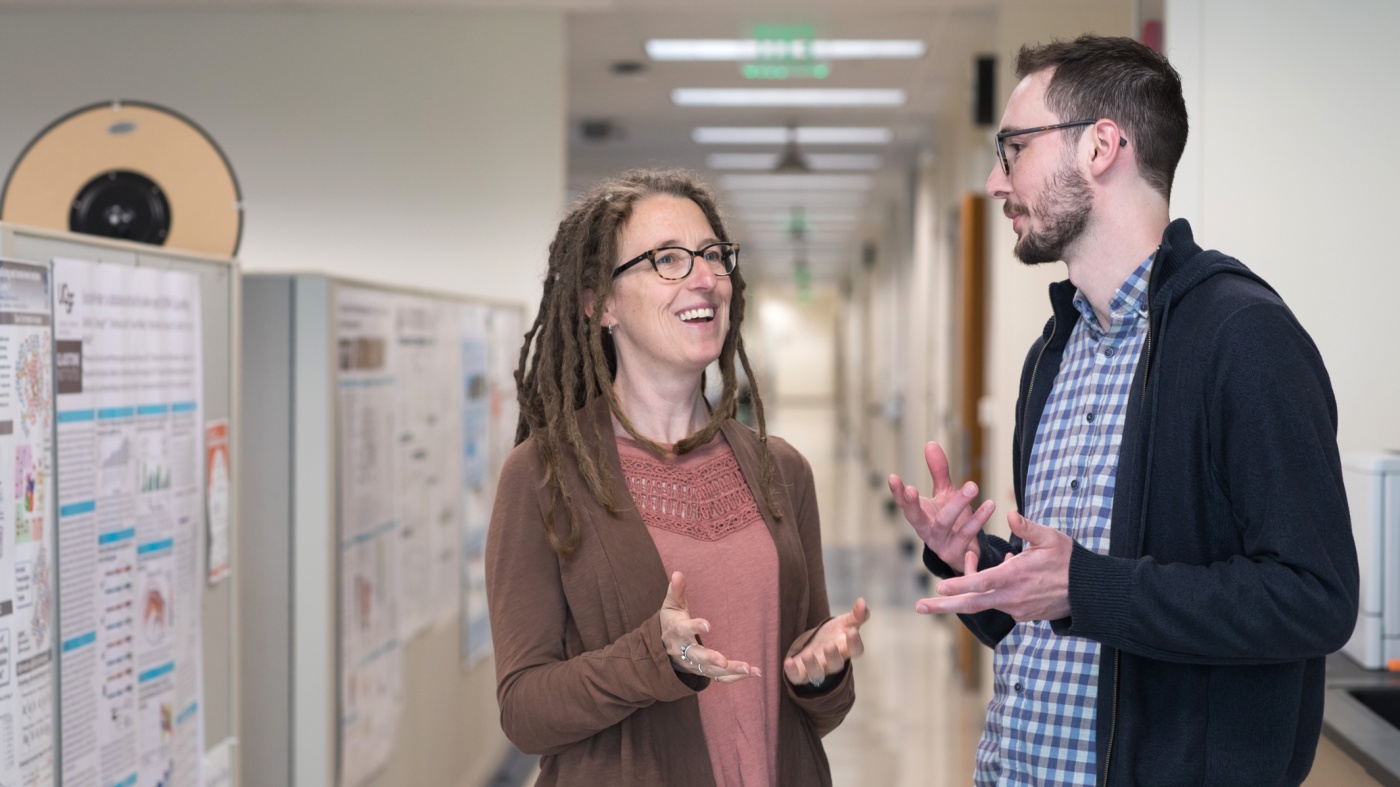 Katherine Pollard and Patrick Bradley talking in the hall
