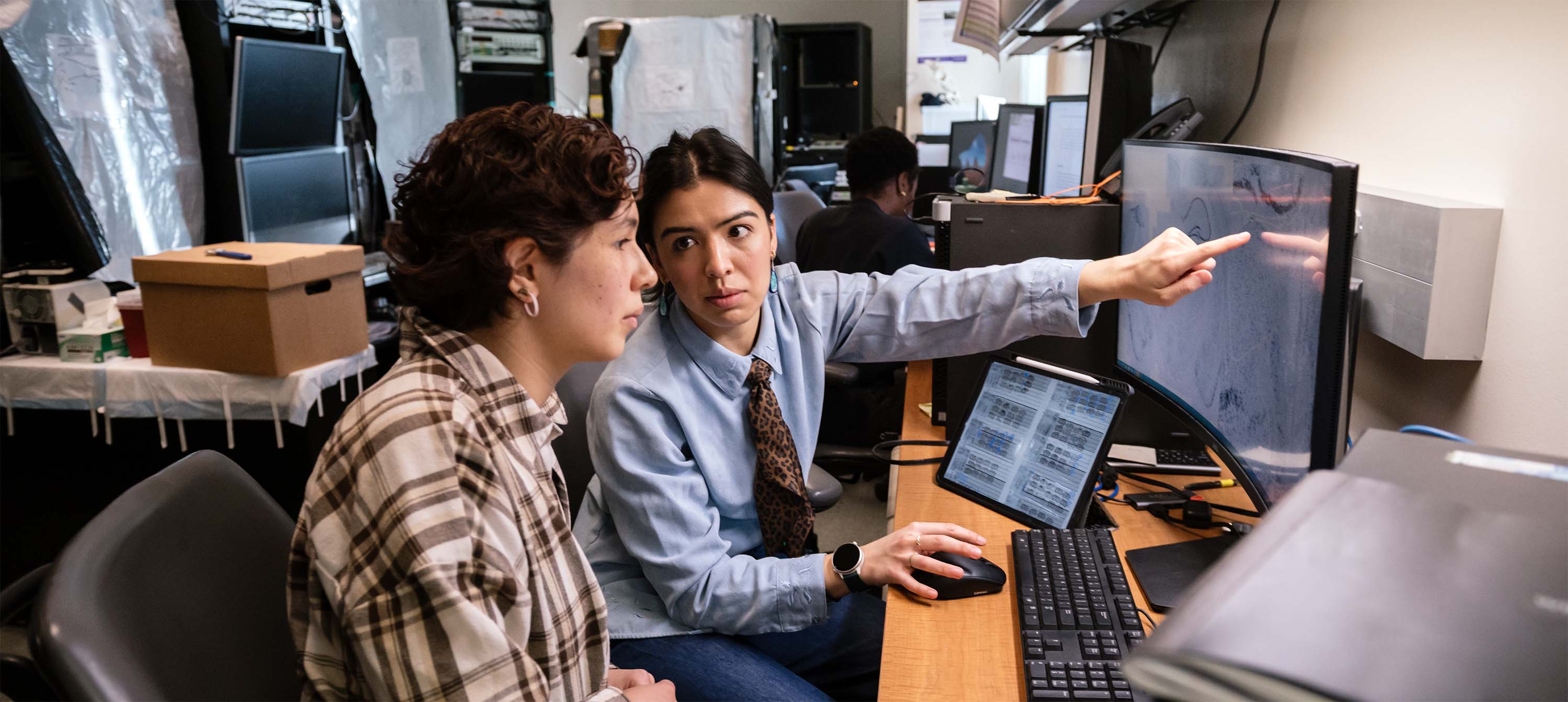 Audrey Magsig working with another scientist at a computer.
