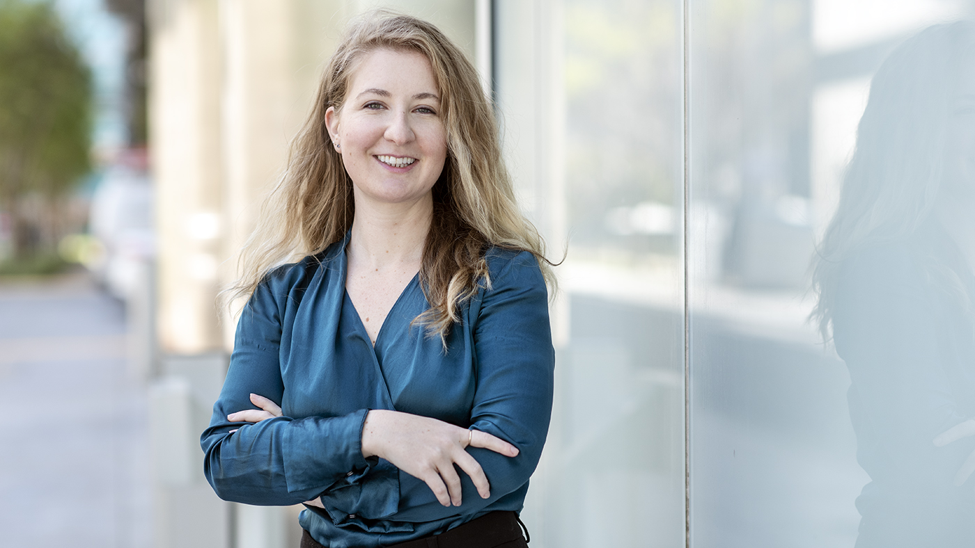 Headshot of Randi Mott standing outside the Gladstone building wearing a blue blouse