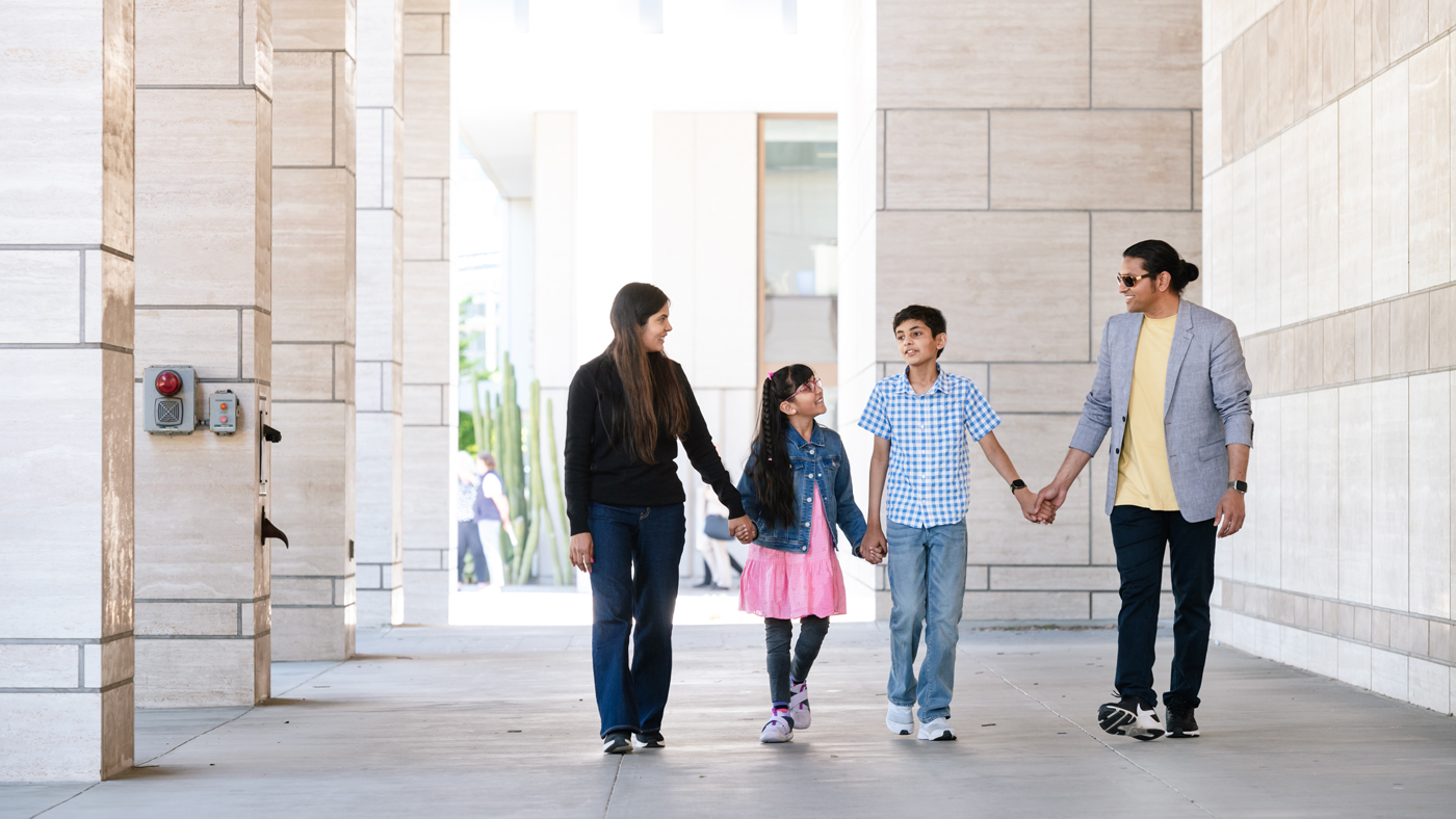 Eight year old Saisha Adokar, who suffers from Charcot-Marie-Tooth Disease, walks through the UCSF campus with her mother Priyanka Lekurwale, father Rahul Adokar, and brother Kinshuk Adokar.