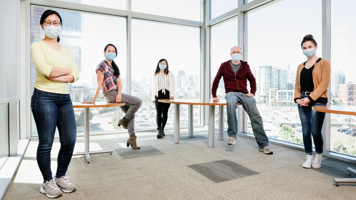 Members of Nadia Roan's lab wearing masks and standing 6 feet a part