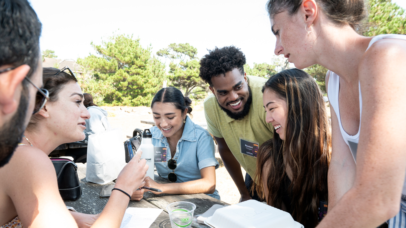 young people socializing around a picnic table