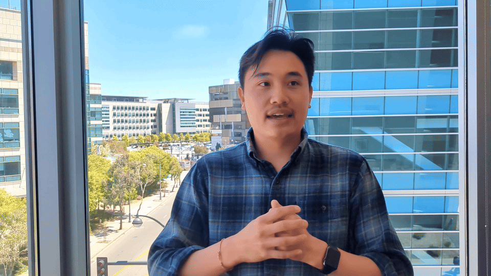 Gif of Oscar Yip sitting for an interview talking with his hands
